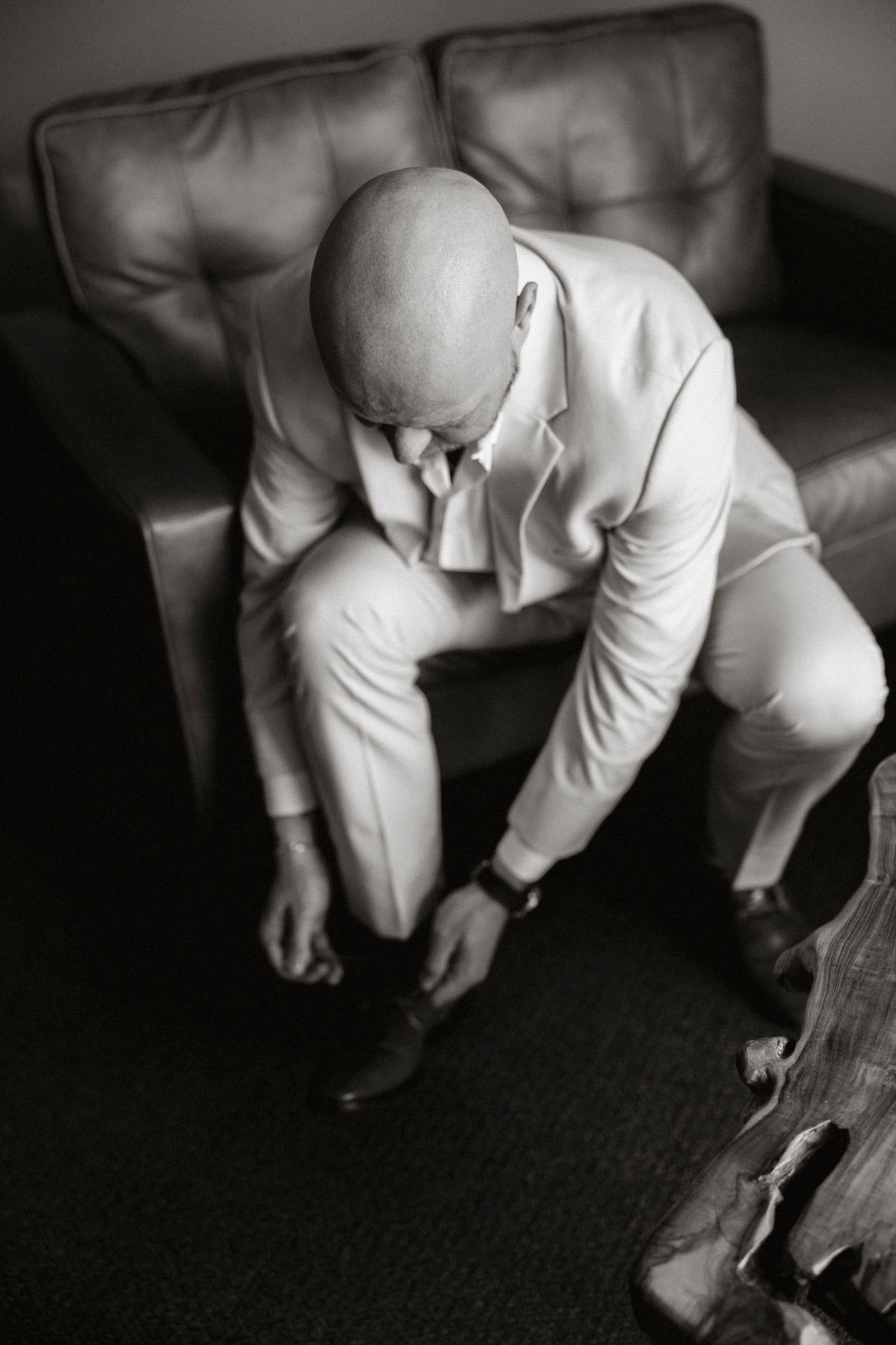 A series of black and white photographs showing a baby in white clothing crawling on dark carpet.