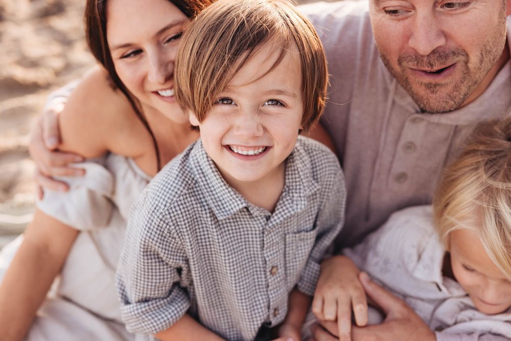 Candid family photo session showing warm interactions and casual poses in an outdoor setting.
