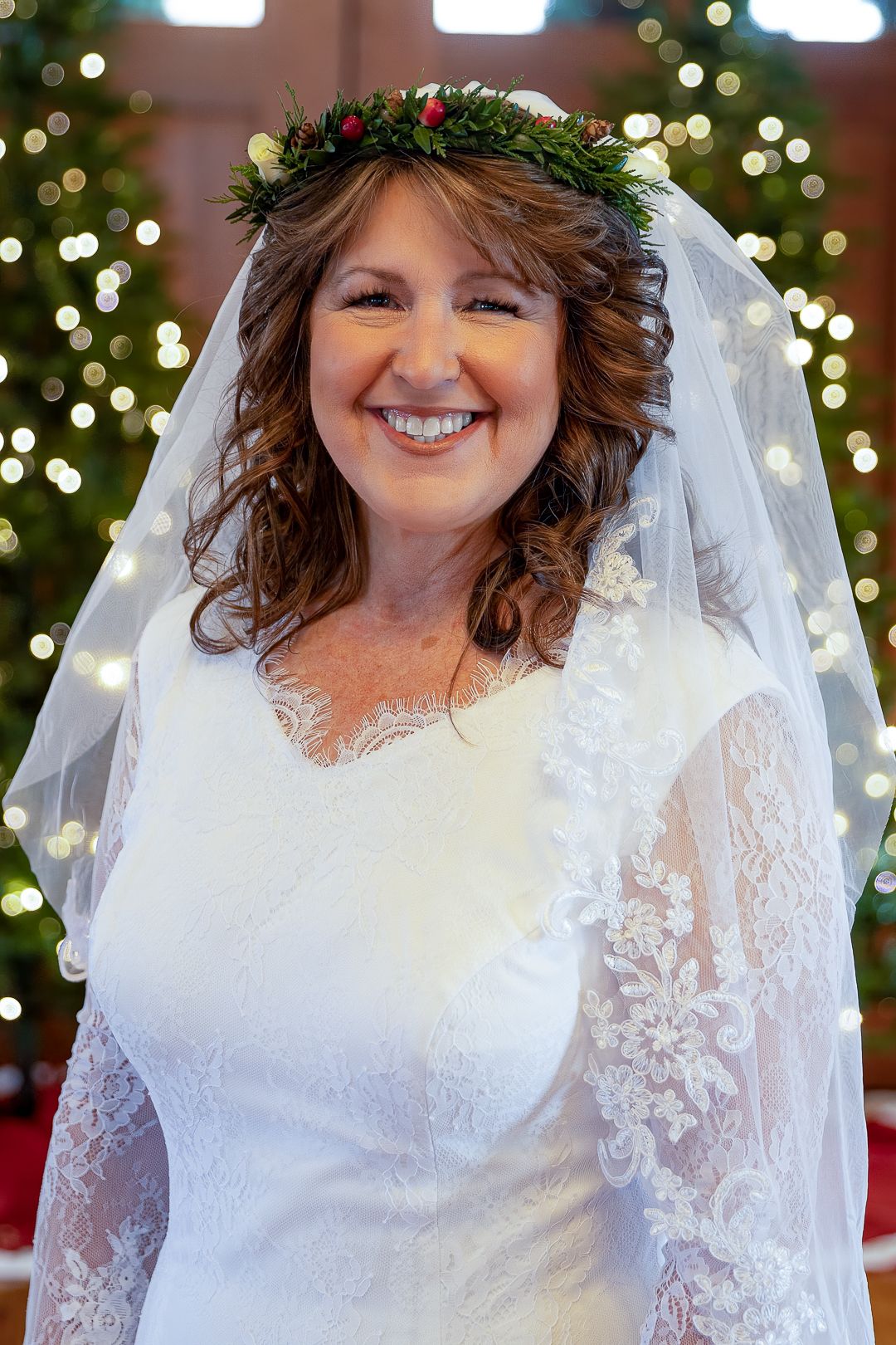 Frederick Maryland Wedding Photographer   A radiant bride in a lace wedding gown poses with a veil and floral crown.