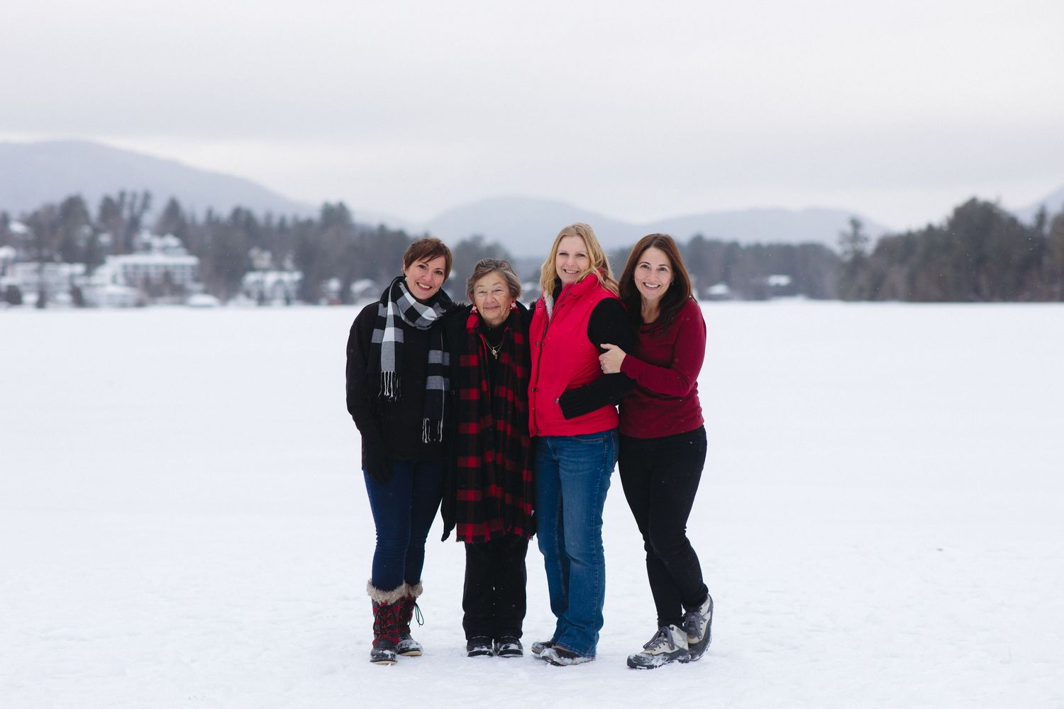 Family members gathered for casual group photos in a snowy winter landscape.