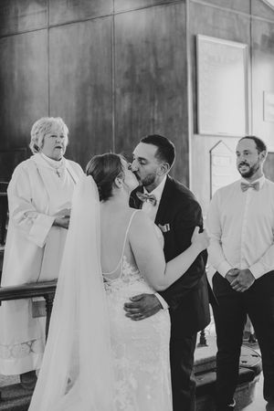 A black and white sequence of candid moments between a wedding couple and guests.