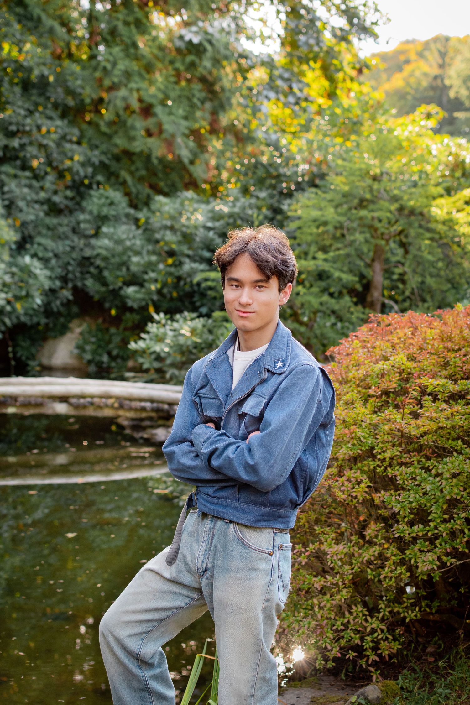 Graduation photo for high school senior by pond at Kubota Garden Seattle