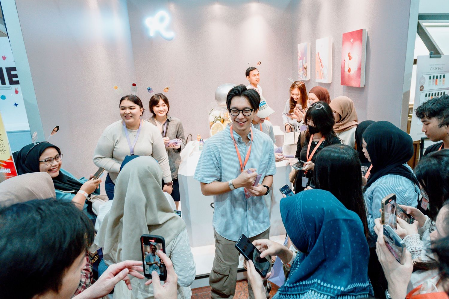 Group of people networking and socializing at a professional business event in a modern office space.