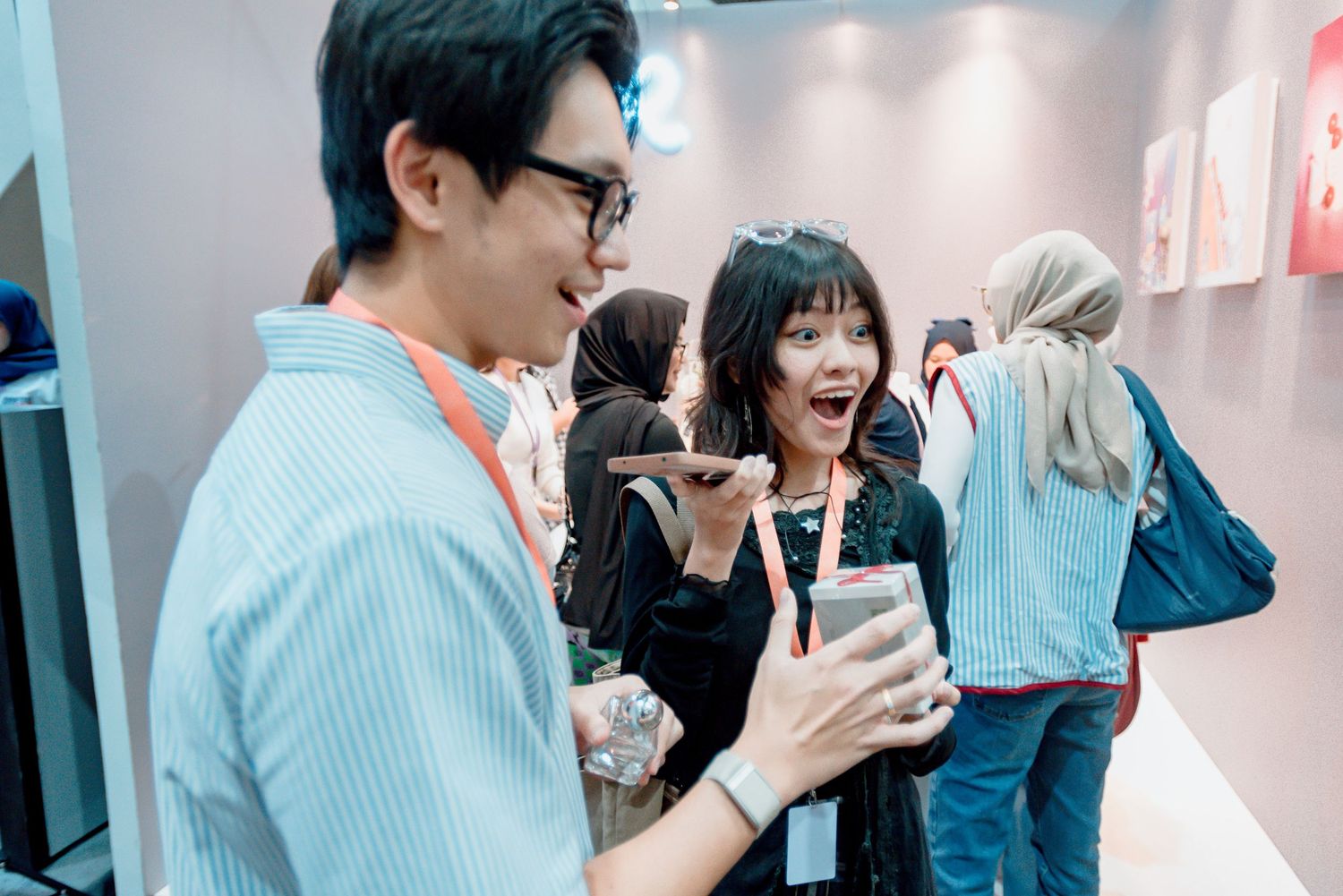 A group of people enjoying beverages and socializing in a bright modern office space.