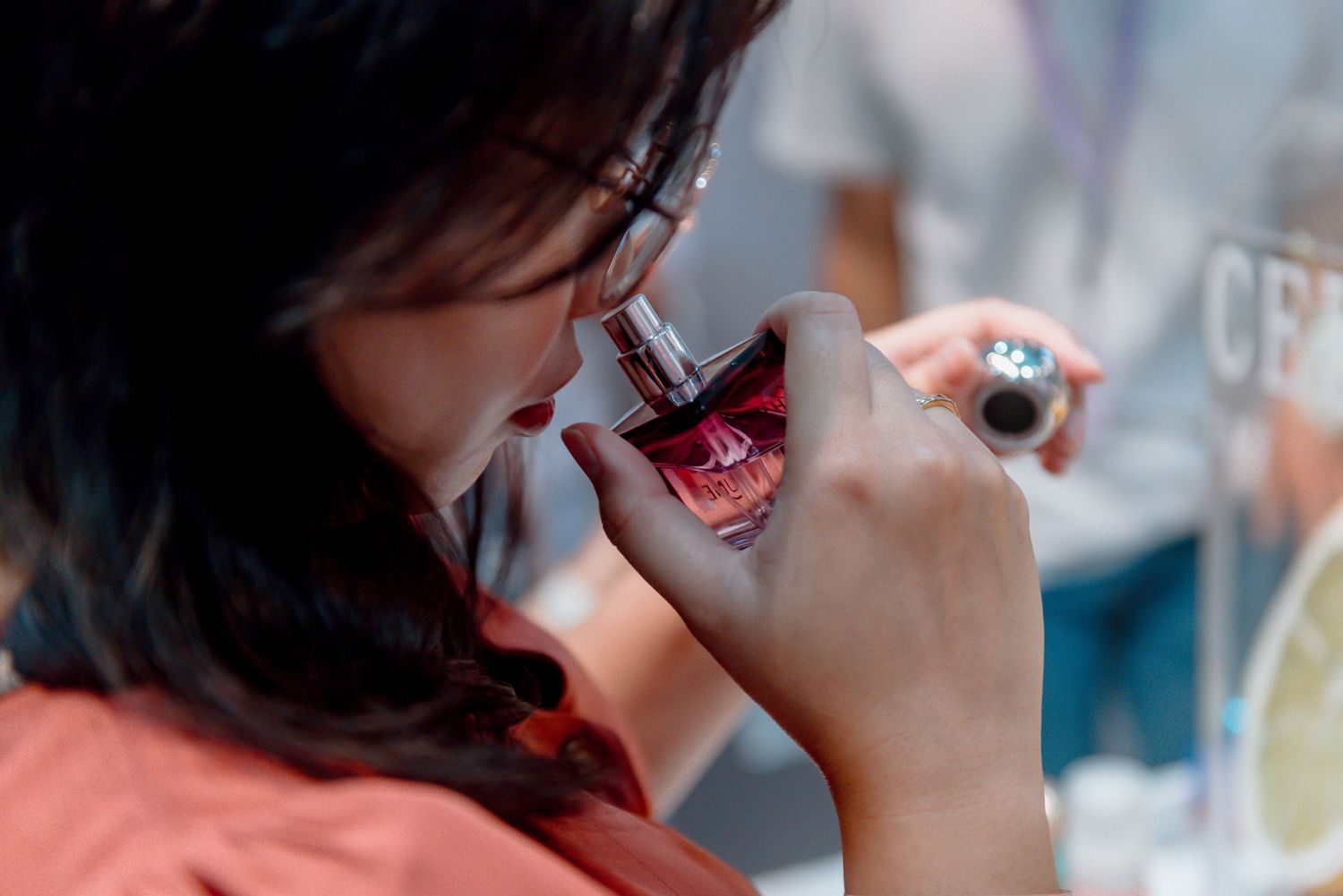 Person sipping red wine from a glass in close-up view during wine tasting.