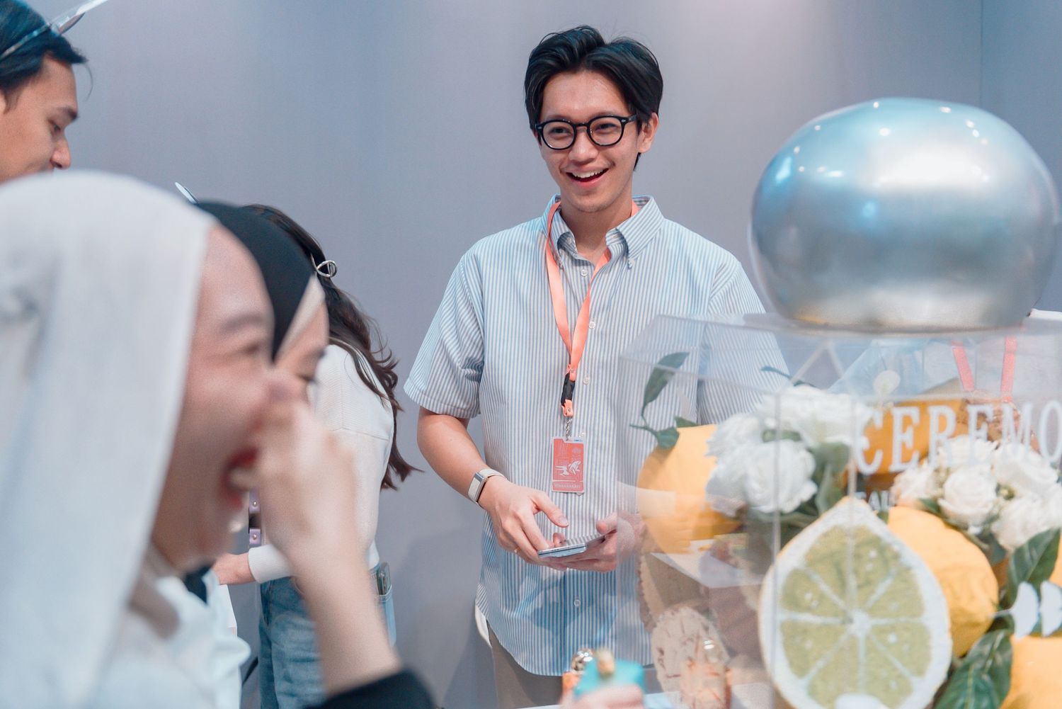 People enjoying drinks and socializing at a bar with cocktails and lemon garnishes in glasses.