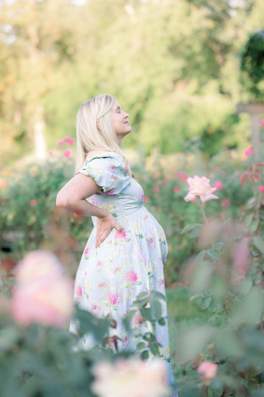 A dreamy triptych shows someone in a floral dress twirling through a soft-focus garden with blooming pink flowers.