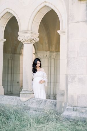 a mother holding her belly at a maternity session in Washington DC at the National Cathedral