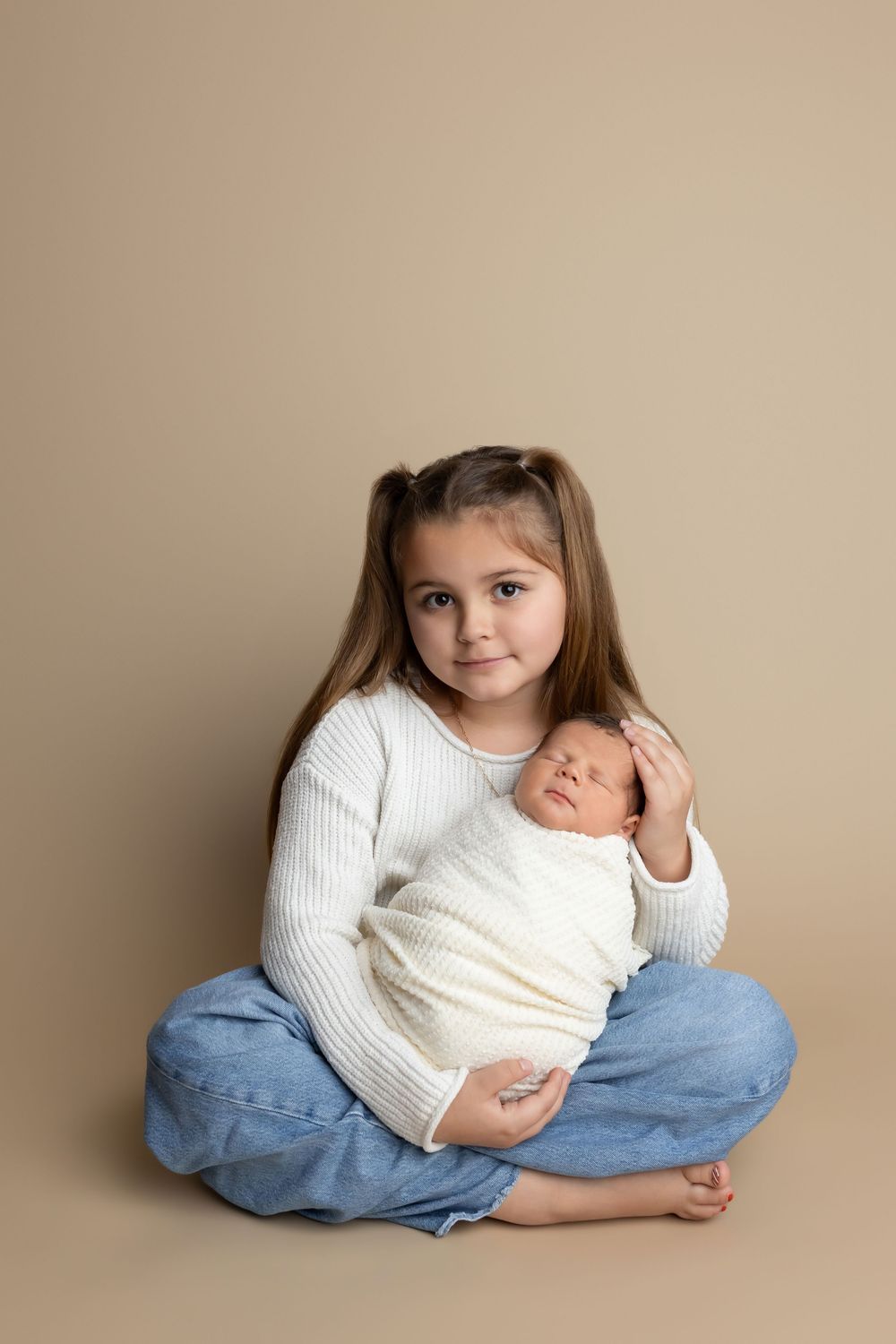 Big sister holding newborn baby, taken by Jen Knightstep, Photographer