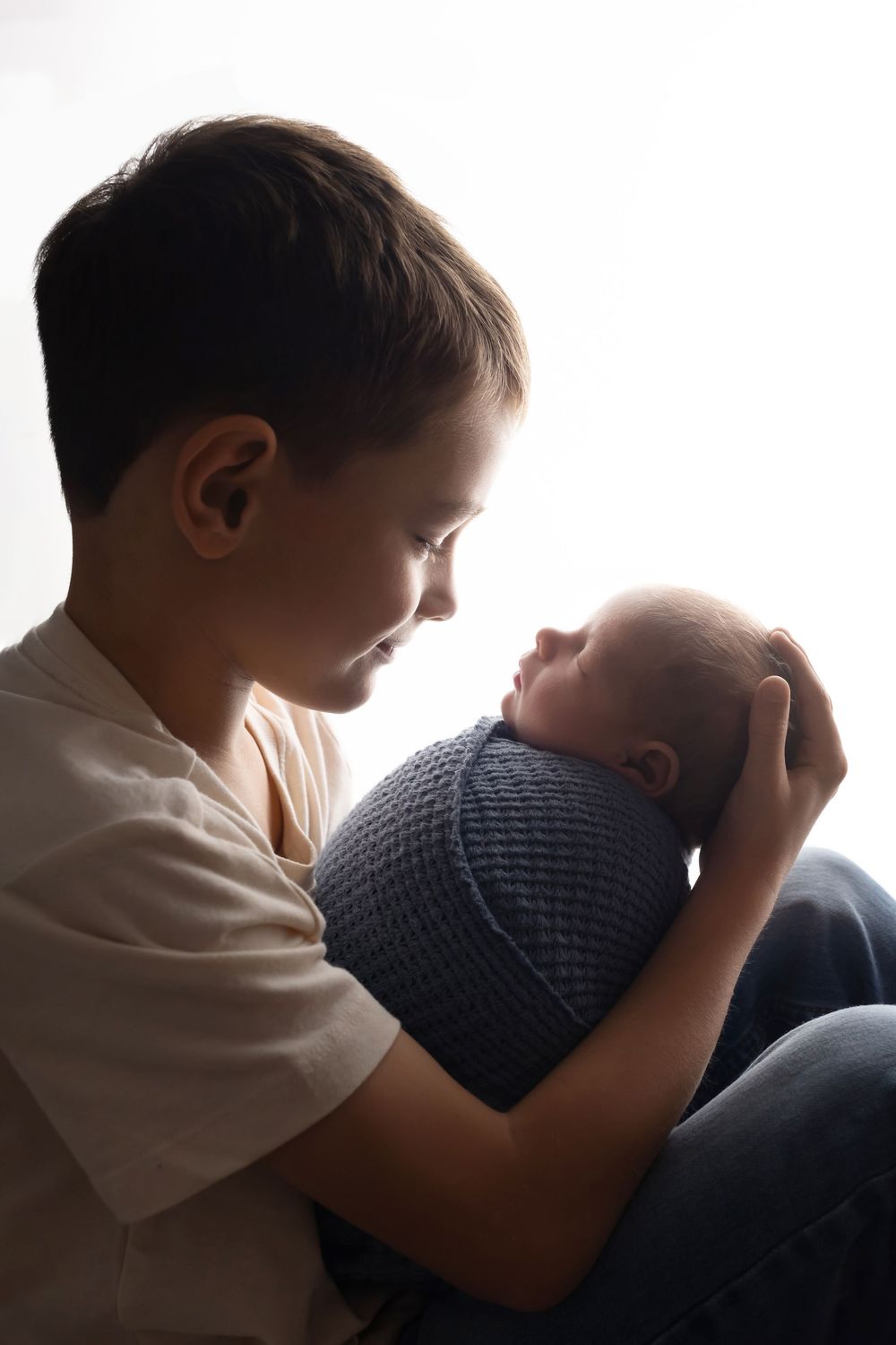 Big brother holding newborn baby, taken by Jen Knightstep, Photographer