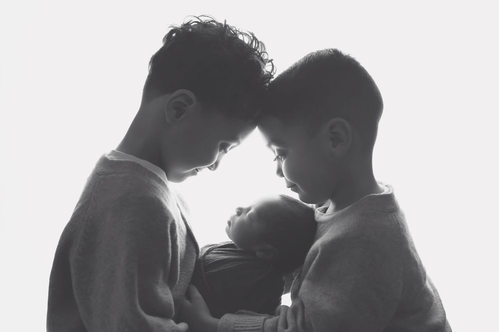 Big brothers holding newborn baby, taken by Jen Knightstep, Photographer