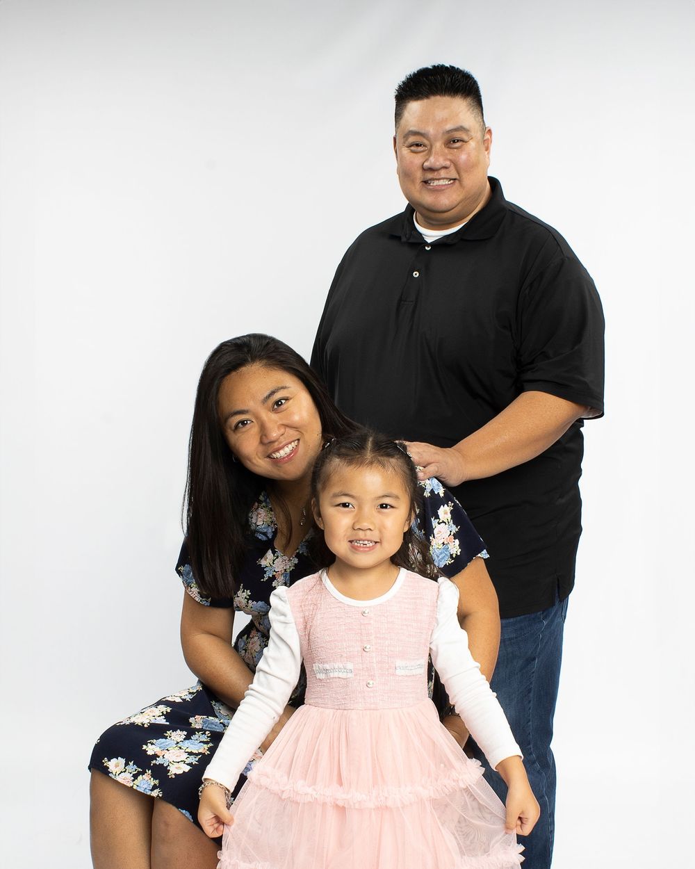 Family of three posing during Family photography session with Student photographer in Fullerton California.