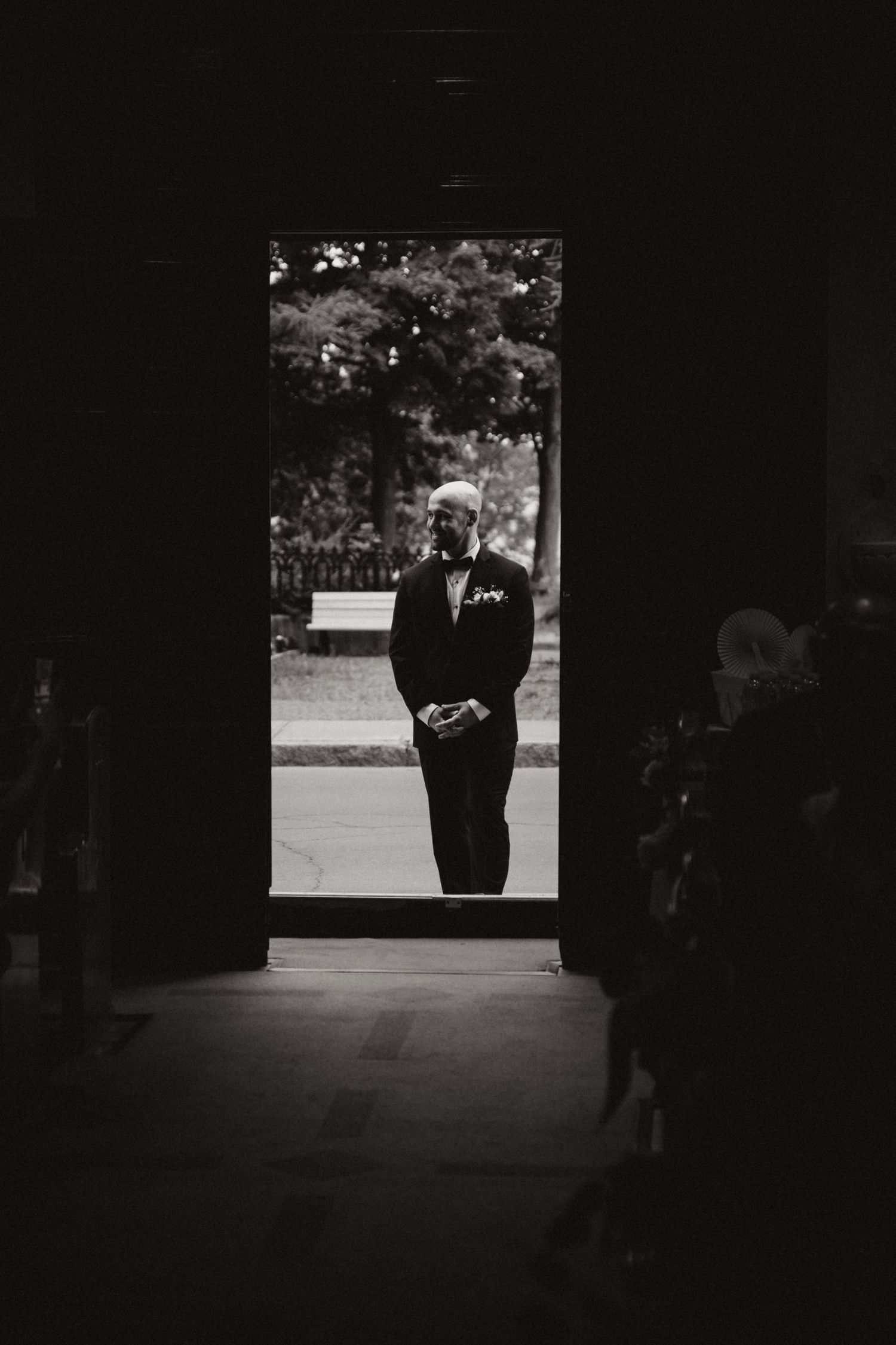 A sequence of black and white photographs showing a dark silhouette walking through a bright doorway.