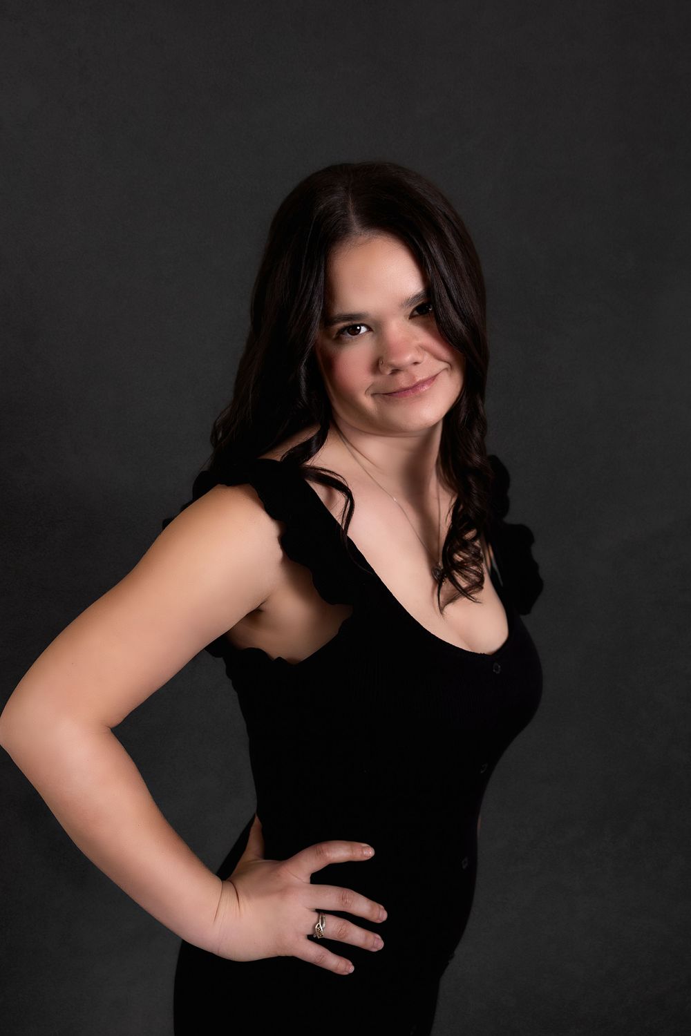 Dramatic studio portraits showing dynamic poses against a dark backdrop.