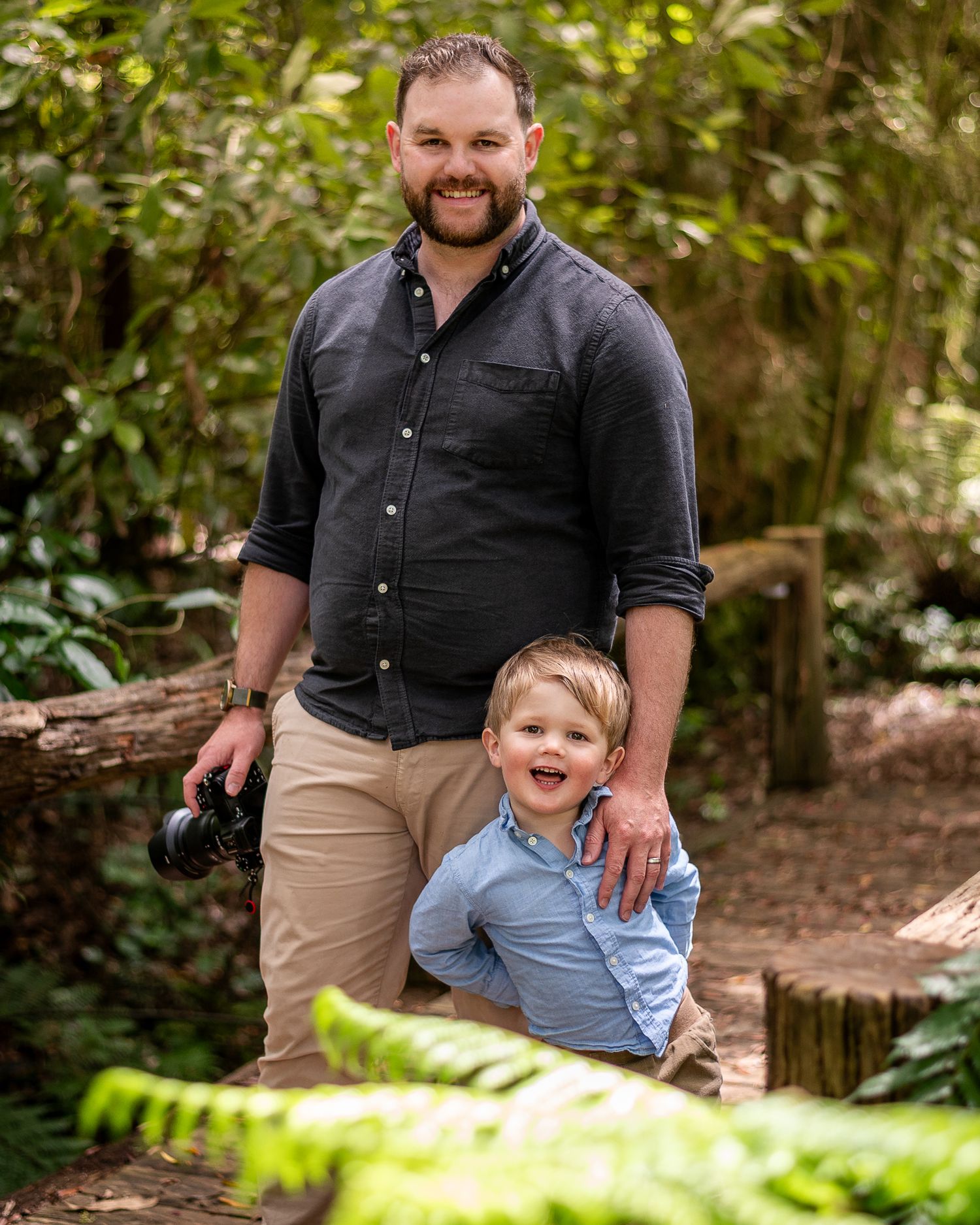 Wedding Photographer standing on a bridge with his son