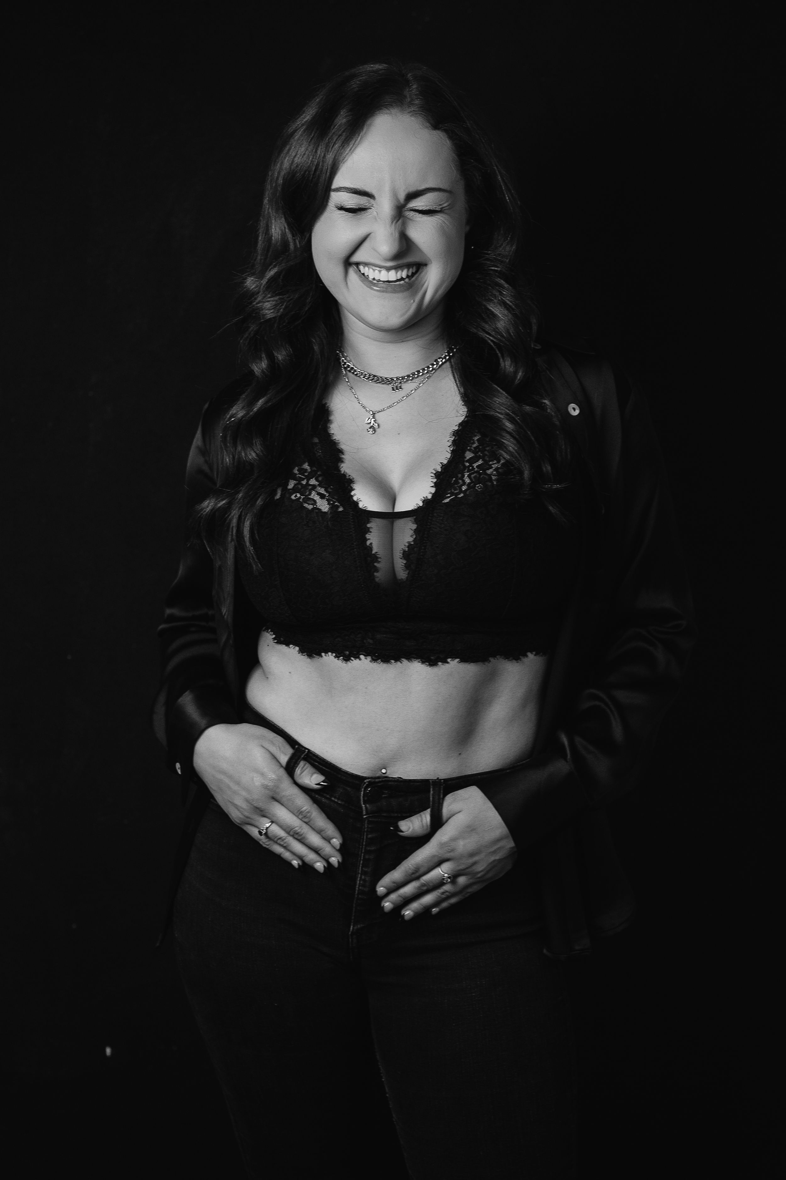 Tasha laughing with thumbs in beltloops