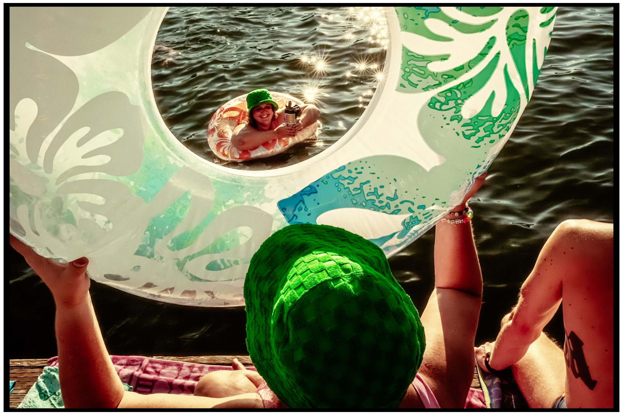 Summer lake view through a decorative porthole with green accents. Willamette River, Portland, OR