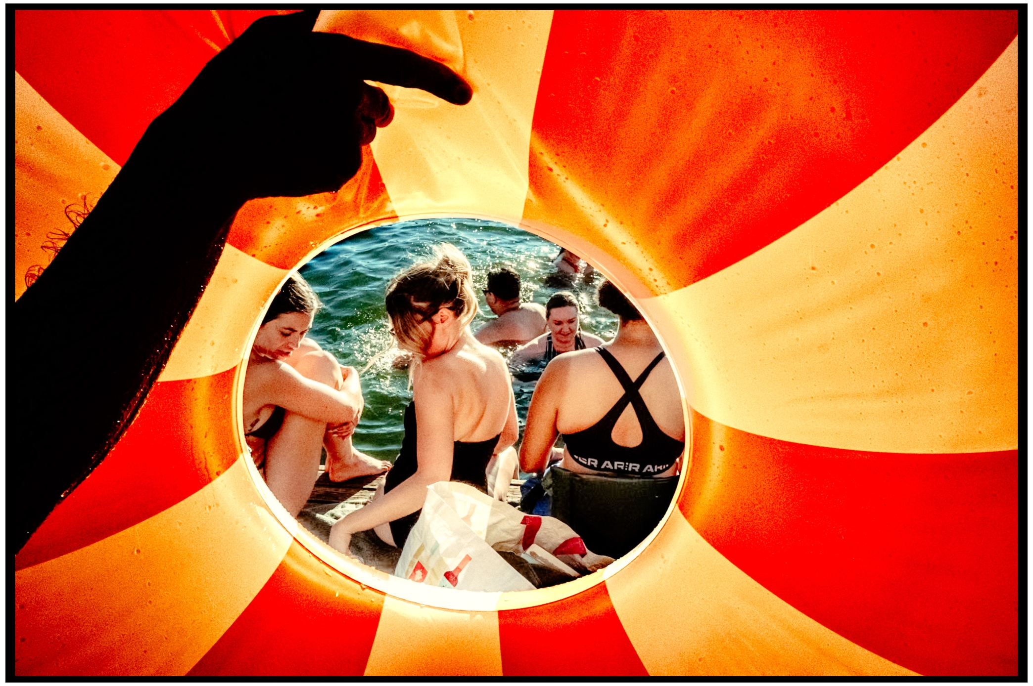Vintage-style circular photo framed by orange sunburst pattern. Willamette River, Portland, OR