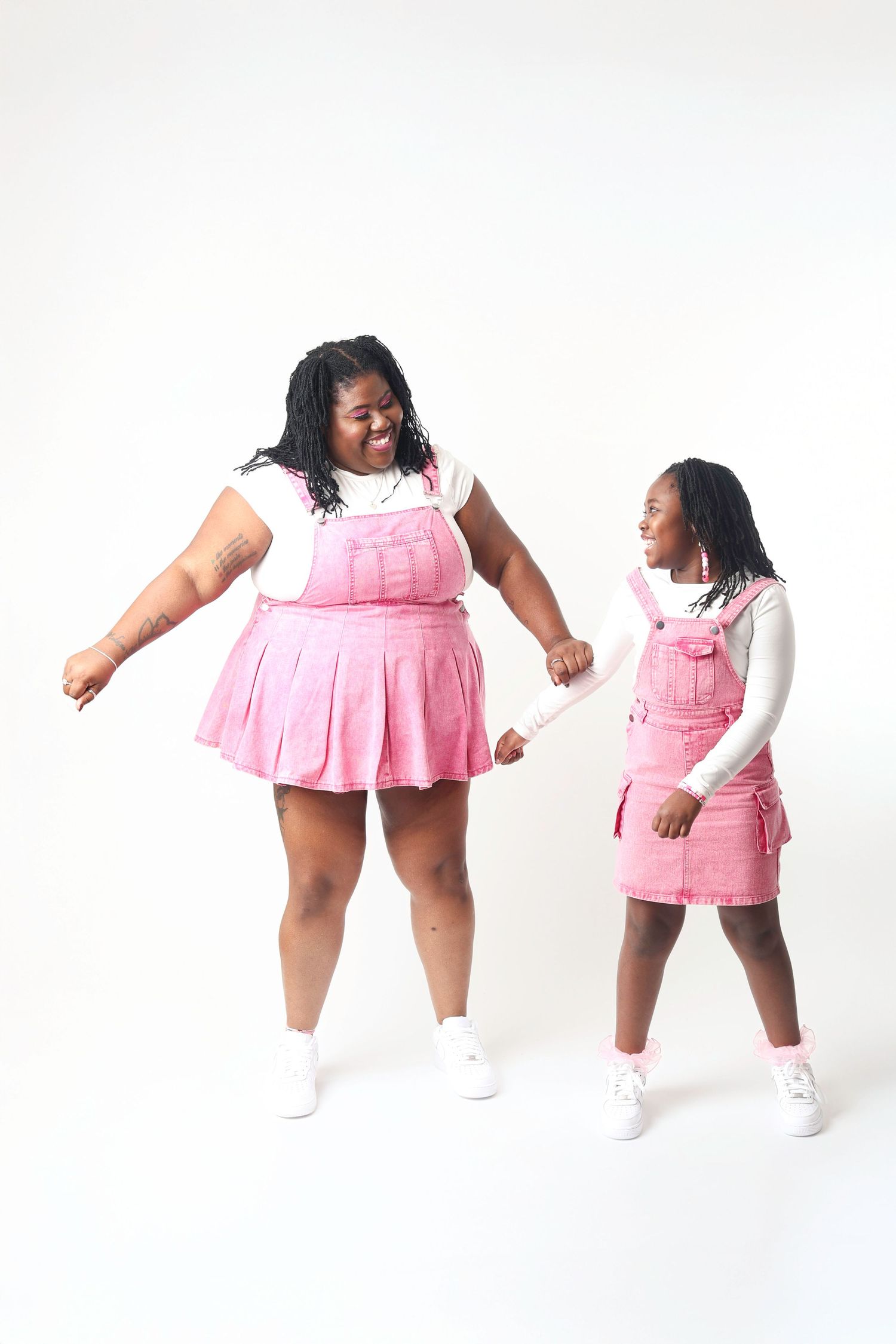 A sequence of dance poses in pink outfits against a white background shows dynamic movement and performance.
