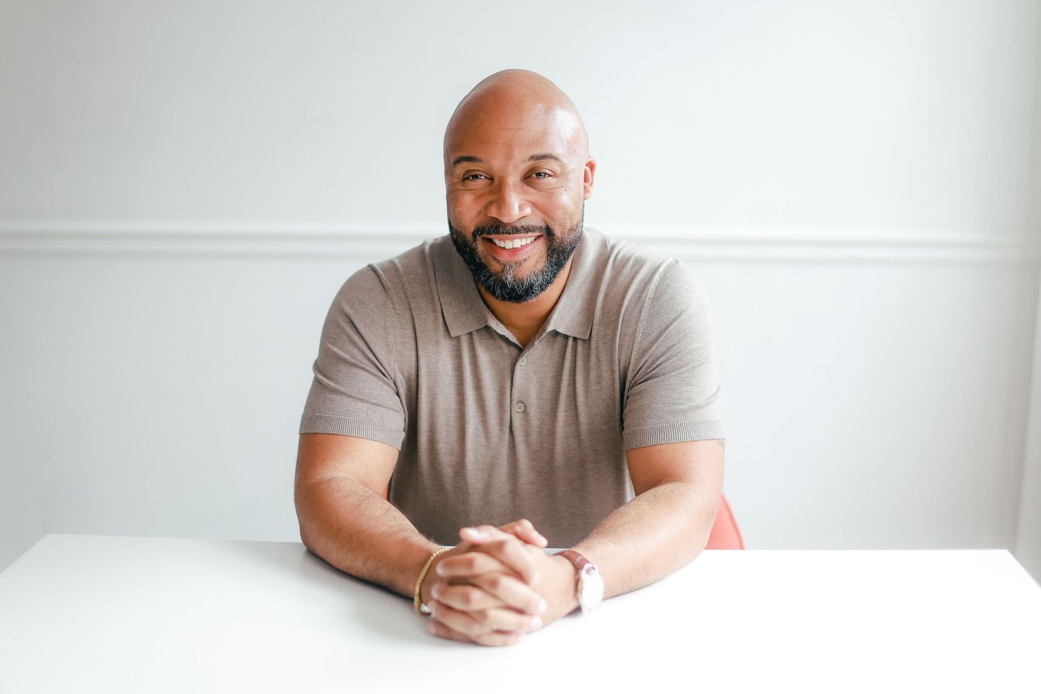 Professional headshots in light and airy style showing welcoming expressions and gray shirt against neutral backgrounds.