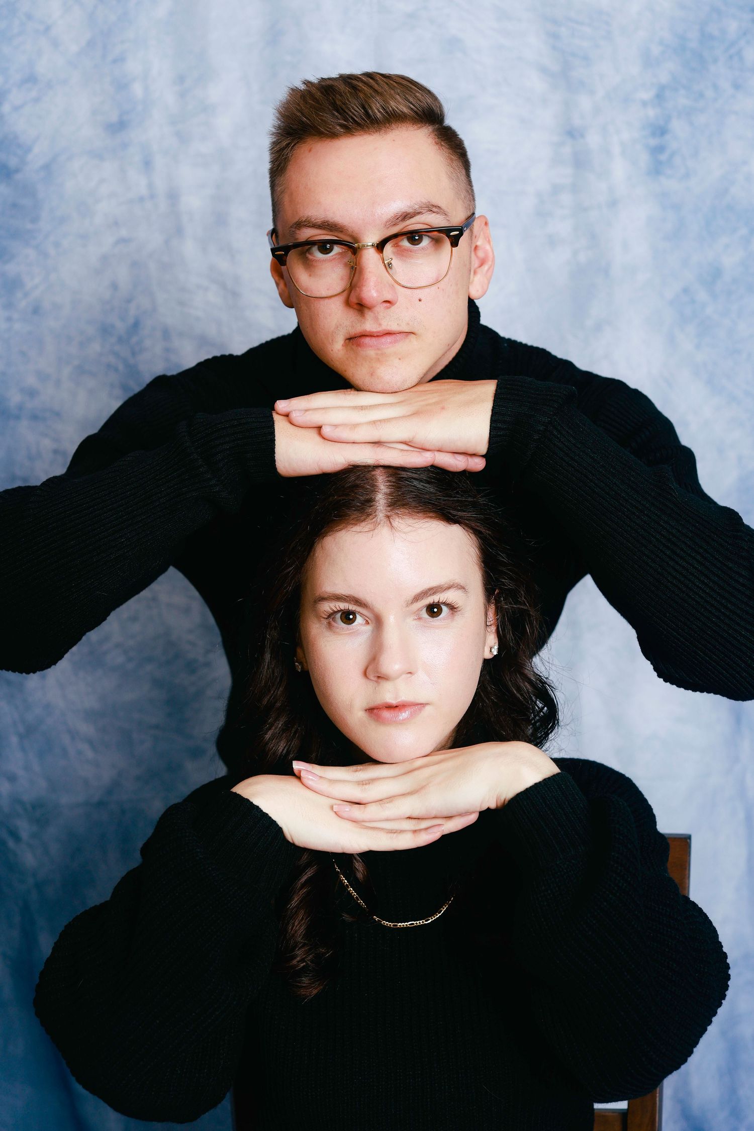 A creative photo series showing hands interacting with a person in a black sweater against a blue mottled backdrop.