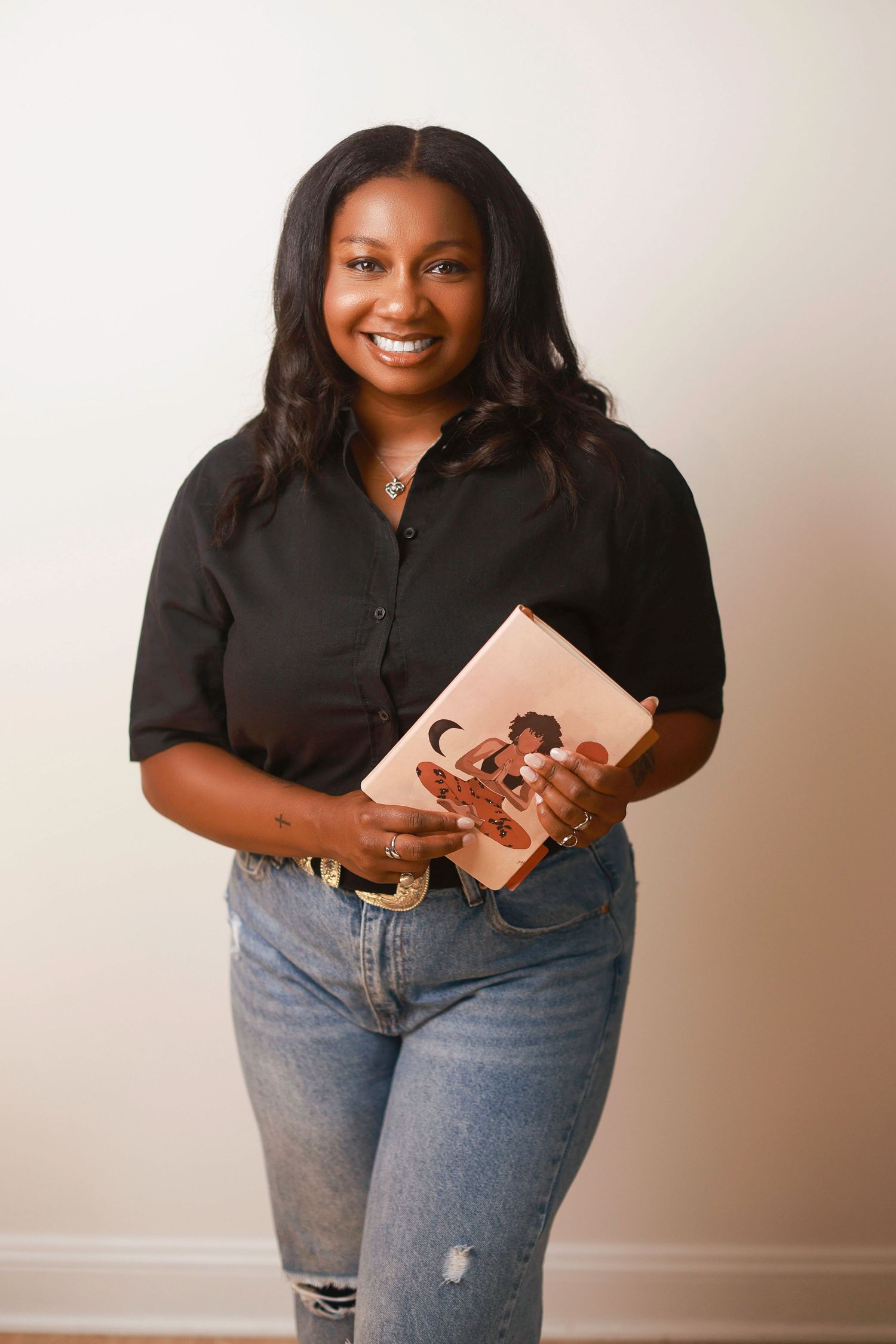 Professional portrait series showing someone in a black shirt and jeans holding a tablet device against a beige wall.