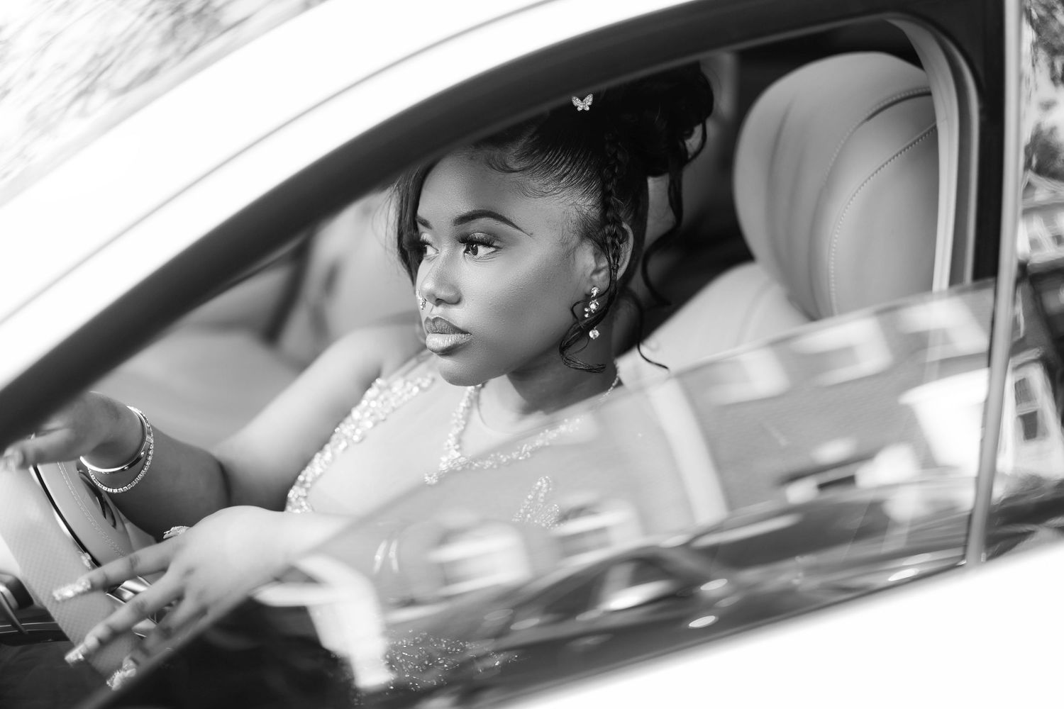 A sophisticated portrait of someone seated in the elegant interior of a luxury Mercedes-Benz vehicle.