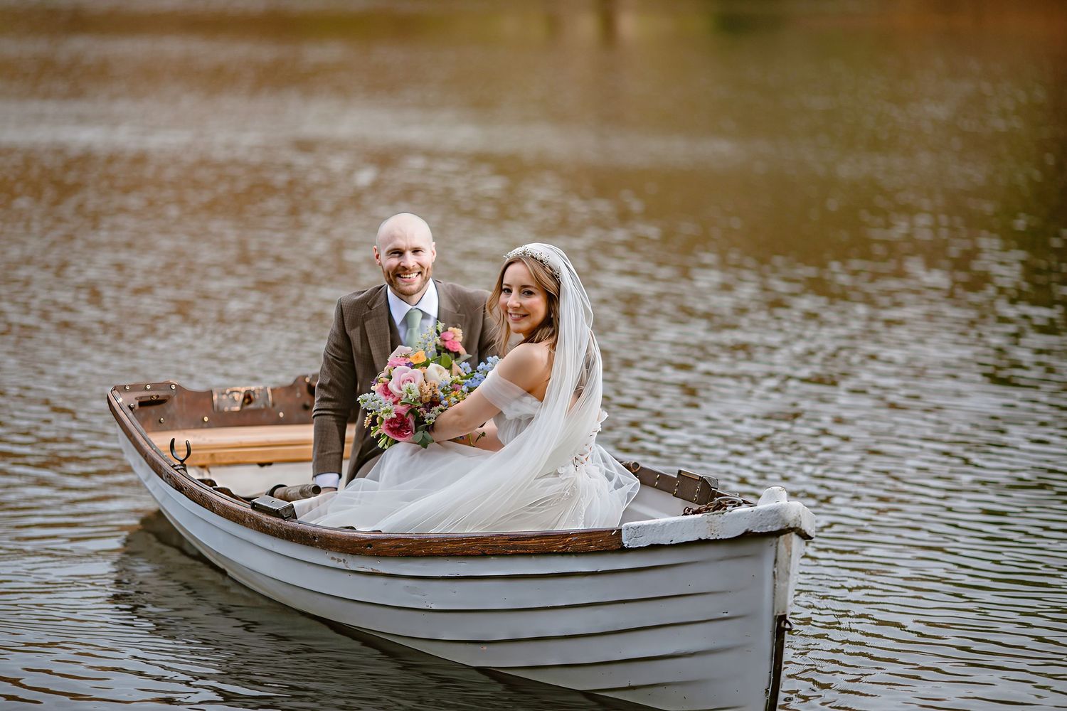 WYRESDALE PARK WEDDING BRIDE AND GROOM IN BOAT ON LAKE