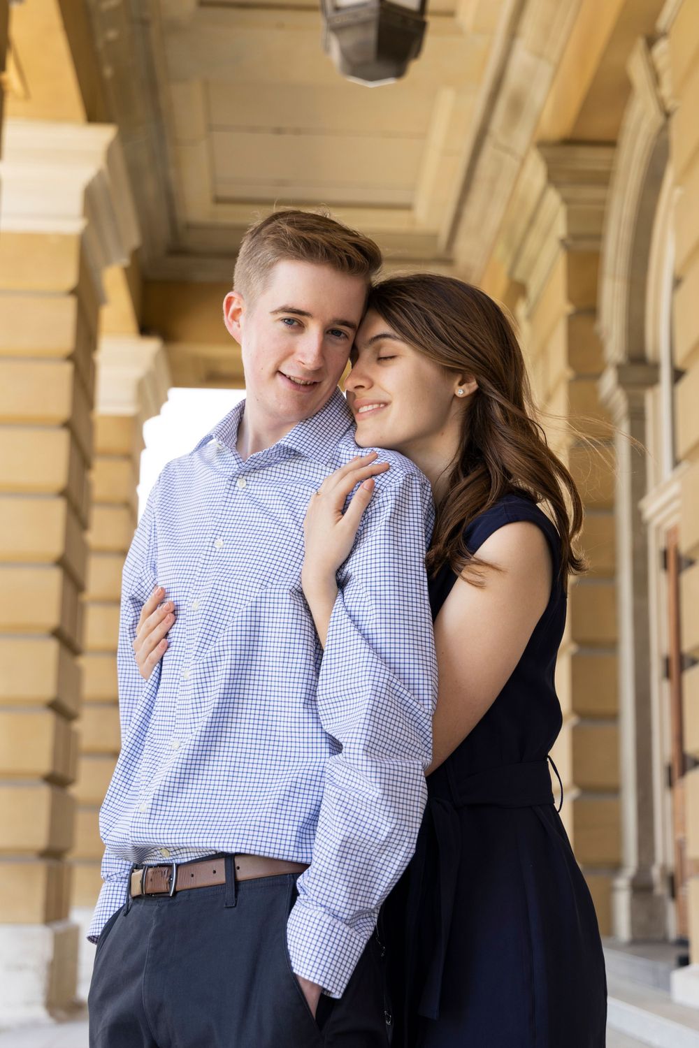 Couple embracing on the front steps of the Des Moines Capital Building.