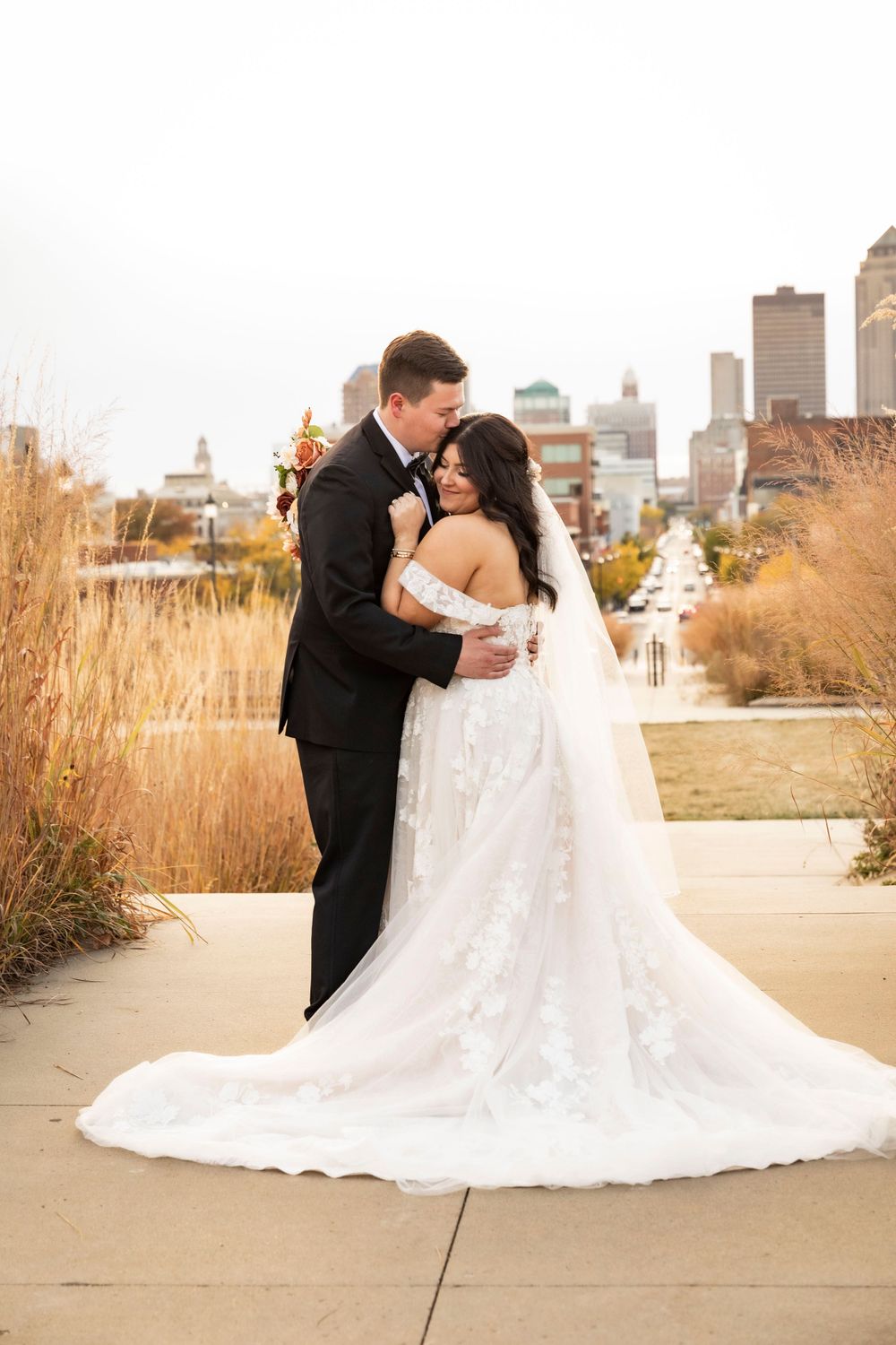 Married couple portrait at the Iowa State Capital with the city view in the background.