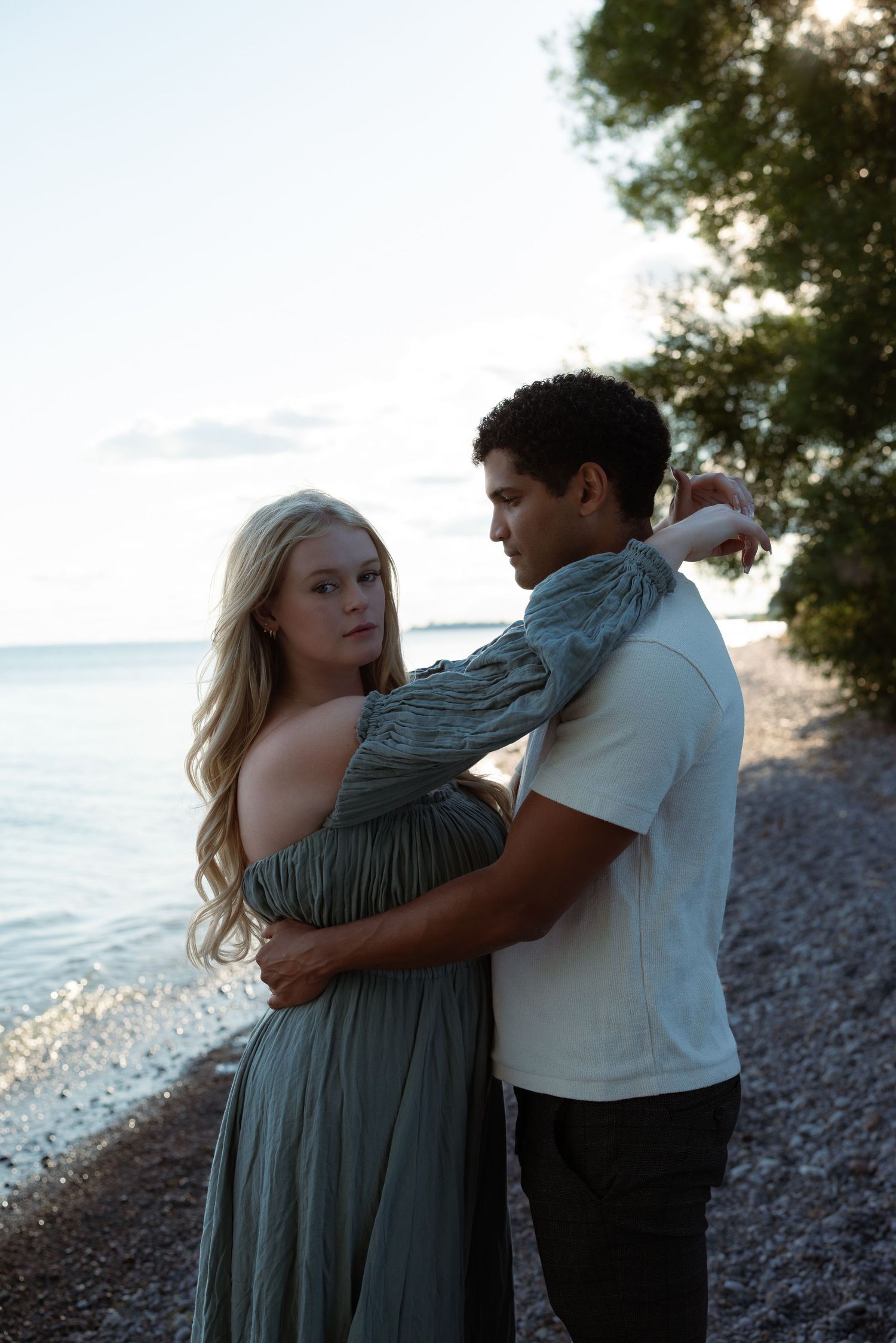Man and woman hugging on the shore, enjoying a quiet moment together.”