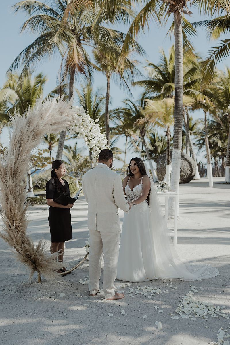 Bride and groom exchanging vows at Blue Venado Riviera Maya beach wedding photographer.