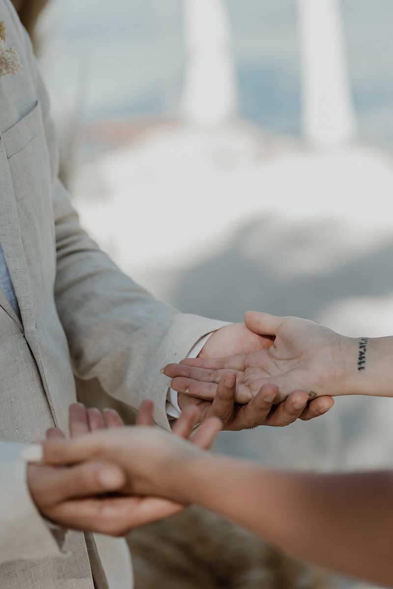 A series of closeup photos showing two people holding hands with a soft blurred background.