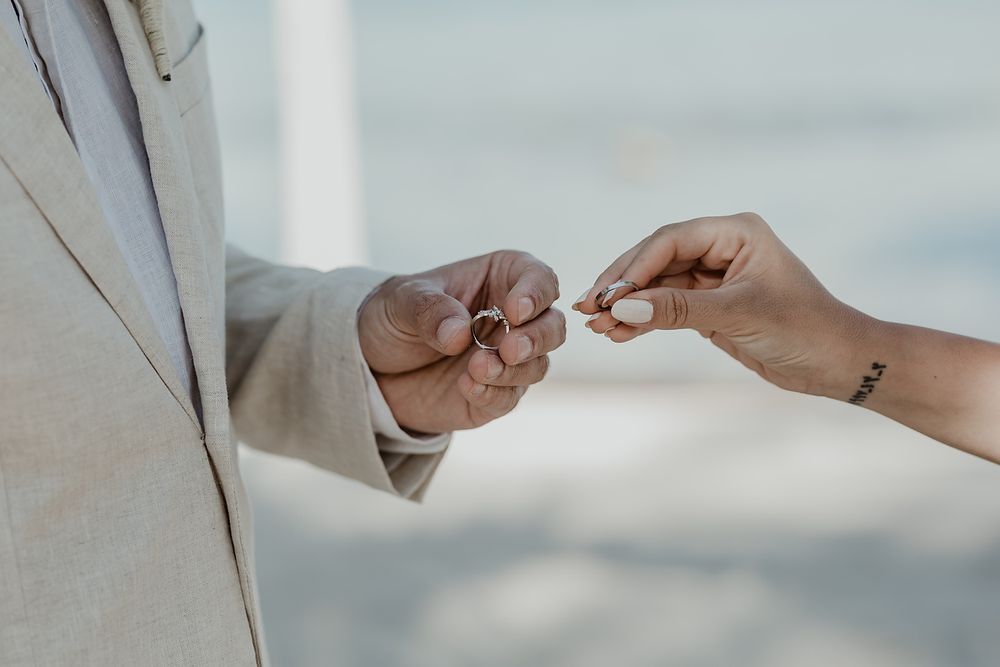 Groom placing wedding ring during Blue Venado Riviera Maya elopement photographer.