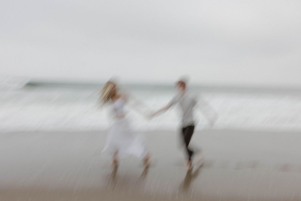 An artistic motion blur of a couple dancing on the beach.