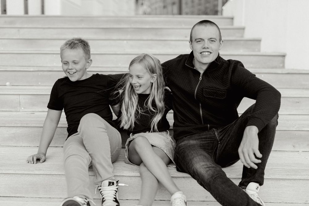 Black and white portrait of people relaxing on outdoor steps.