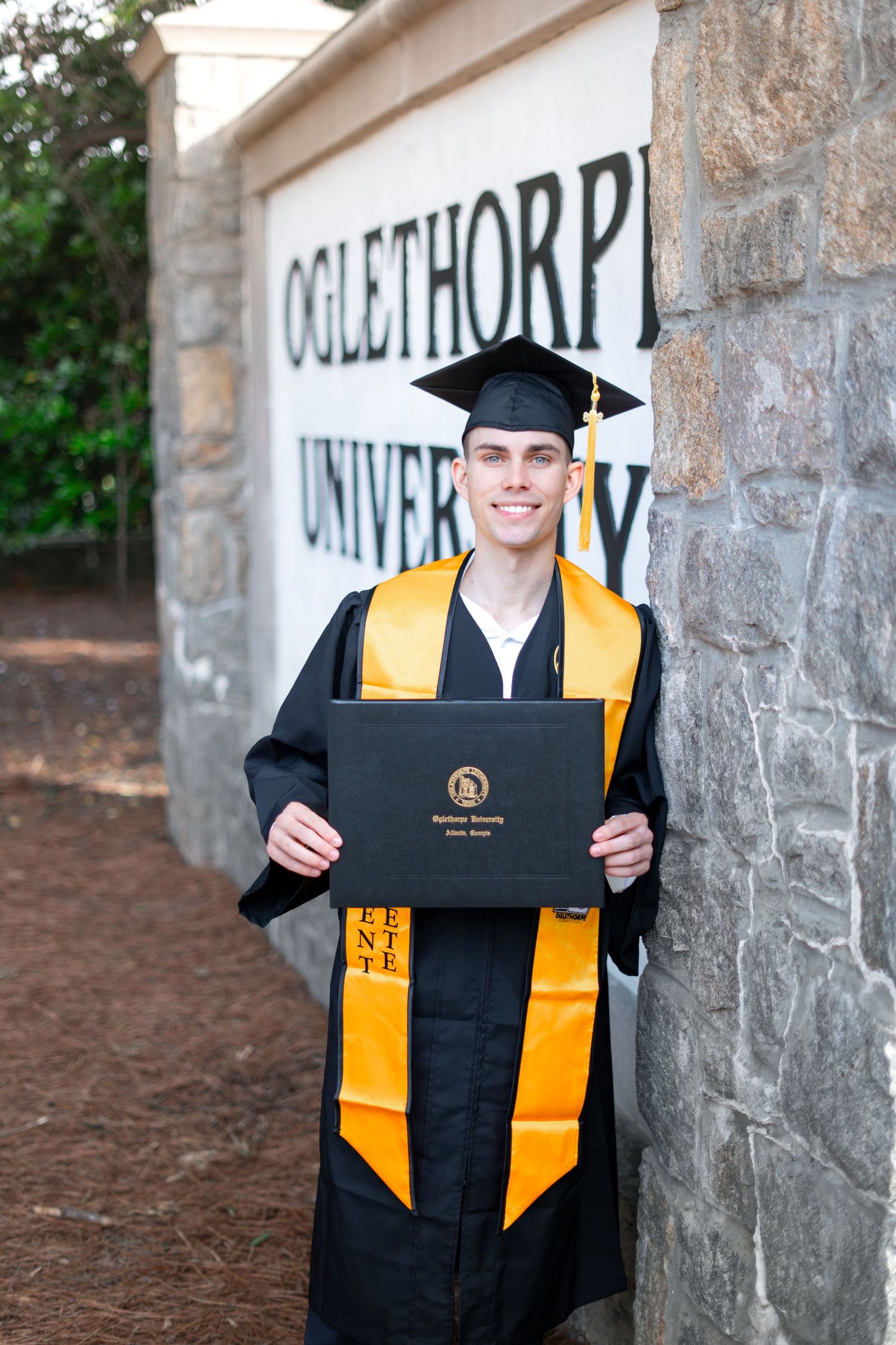 Oglethorpe graduation photos at the OU welcome sign, one of the best spots for Oglethorpe grad portraits in Brookhaven, atlanta
