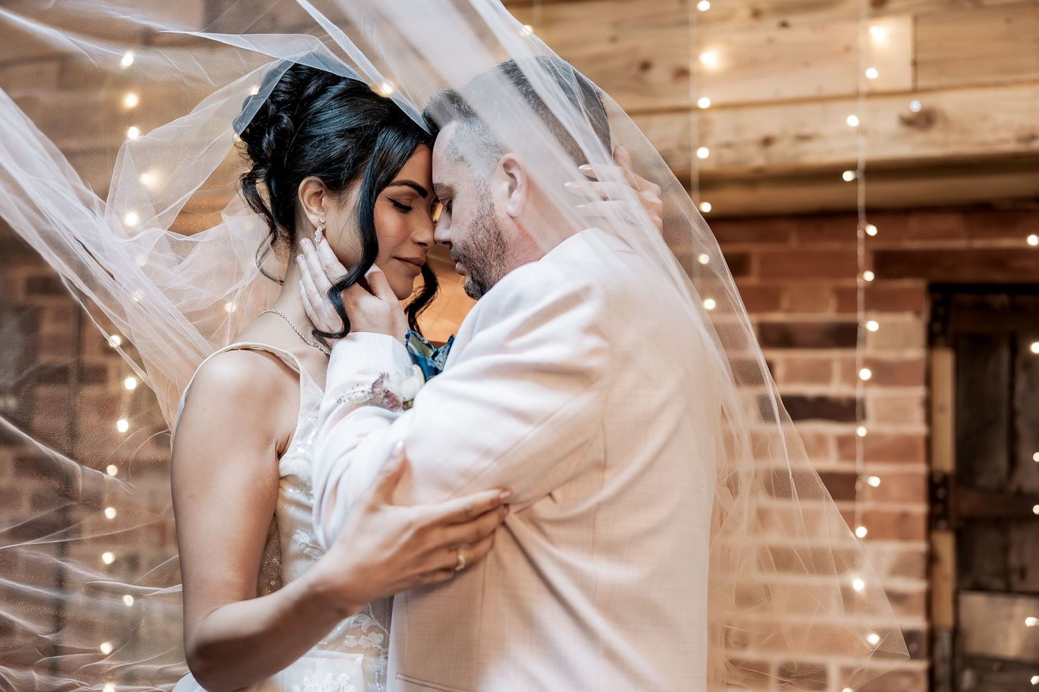 couple share a moment together during their ceremony at their barn wedding venue.