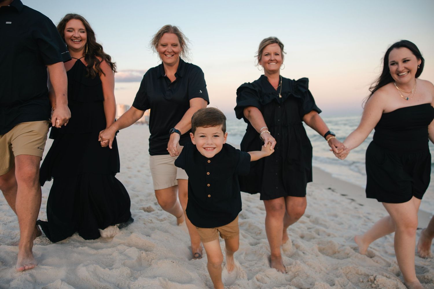 newly engaged couple cuddling on a emerald coast beach