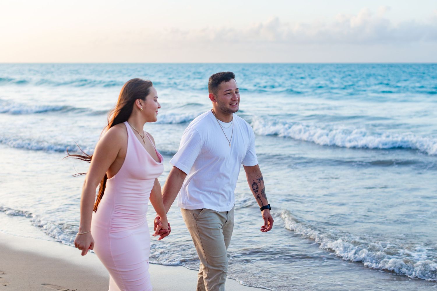 Couples portrait walking along the beach in Isla Verde, Carolina, Puerto Rico.