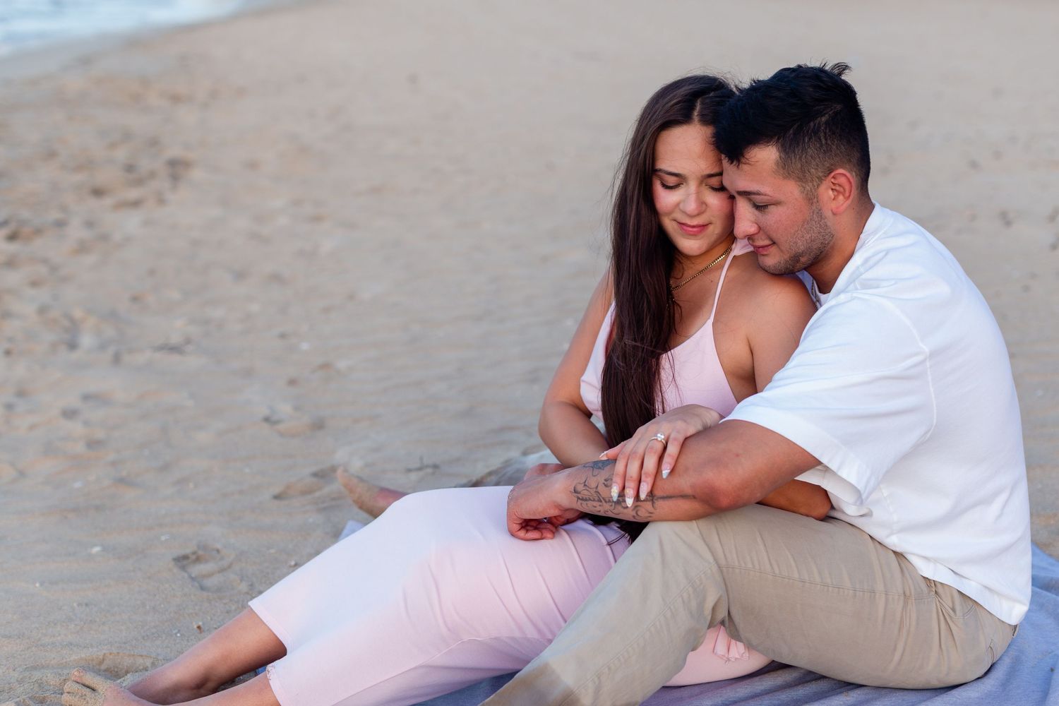 Couples portrait seated at the beach in Isla Verde, Carolina, Puerto Rico.