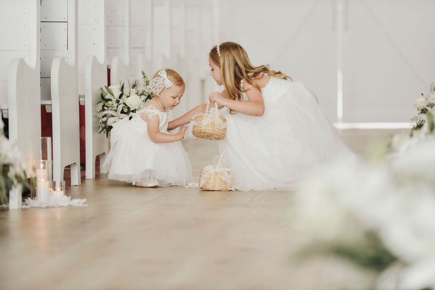 Sweet flower girls walking toward altar