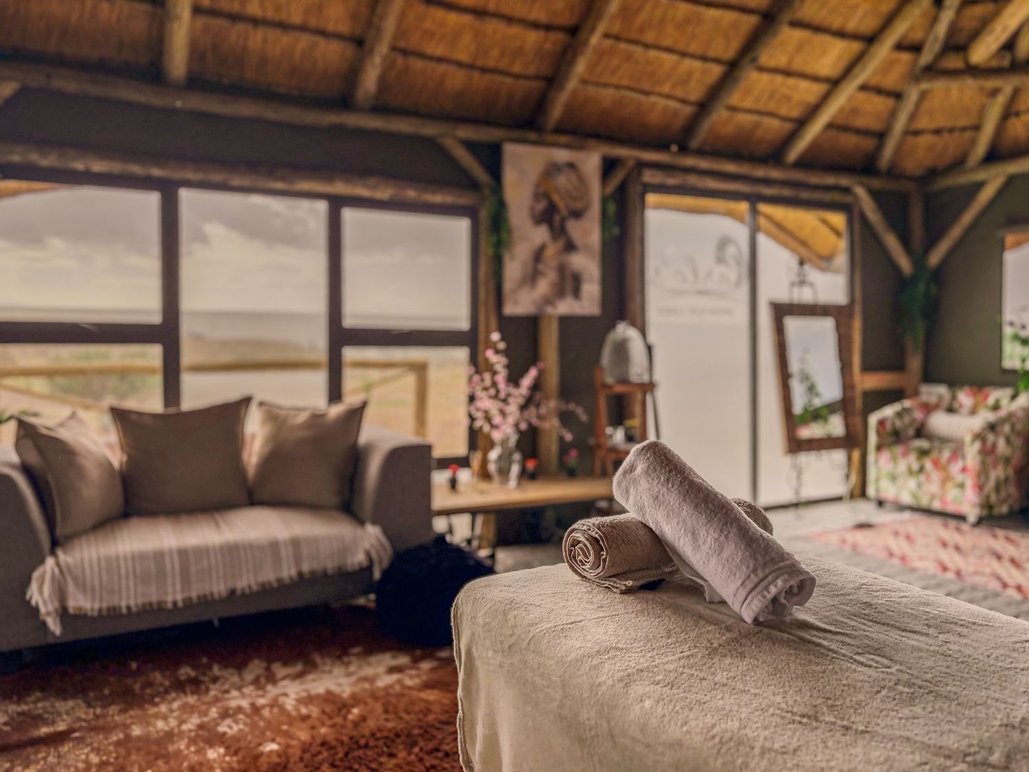 thatched suite
Rustic safari suite interior with thatched roof, large window overlooking the Namibian landscape, sofa seating and patterned