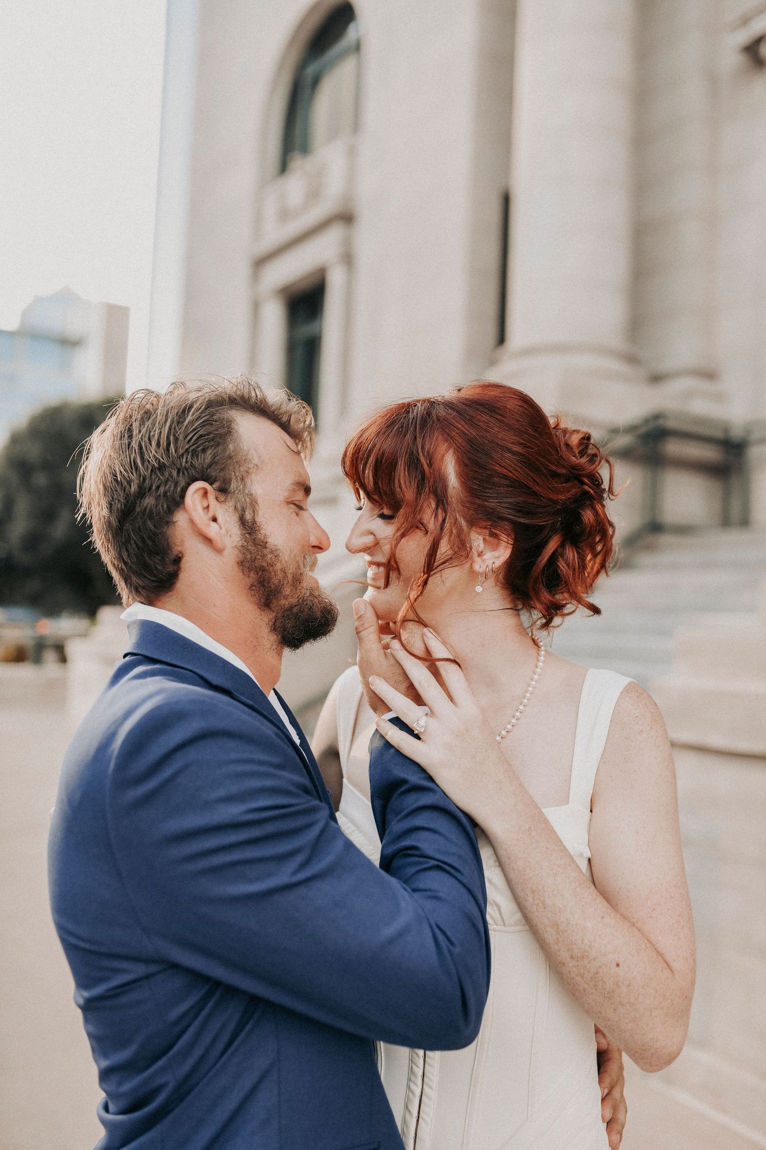 Candid engagement photo of couple laughing together in Downtown Dallas
