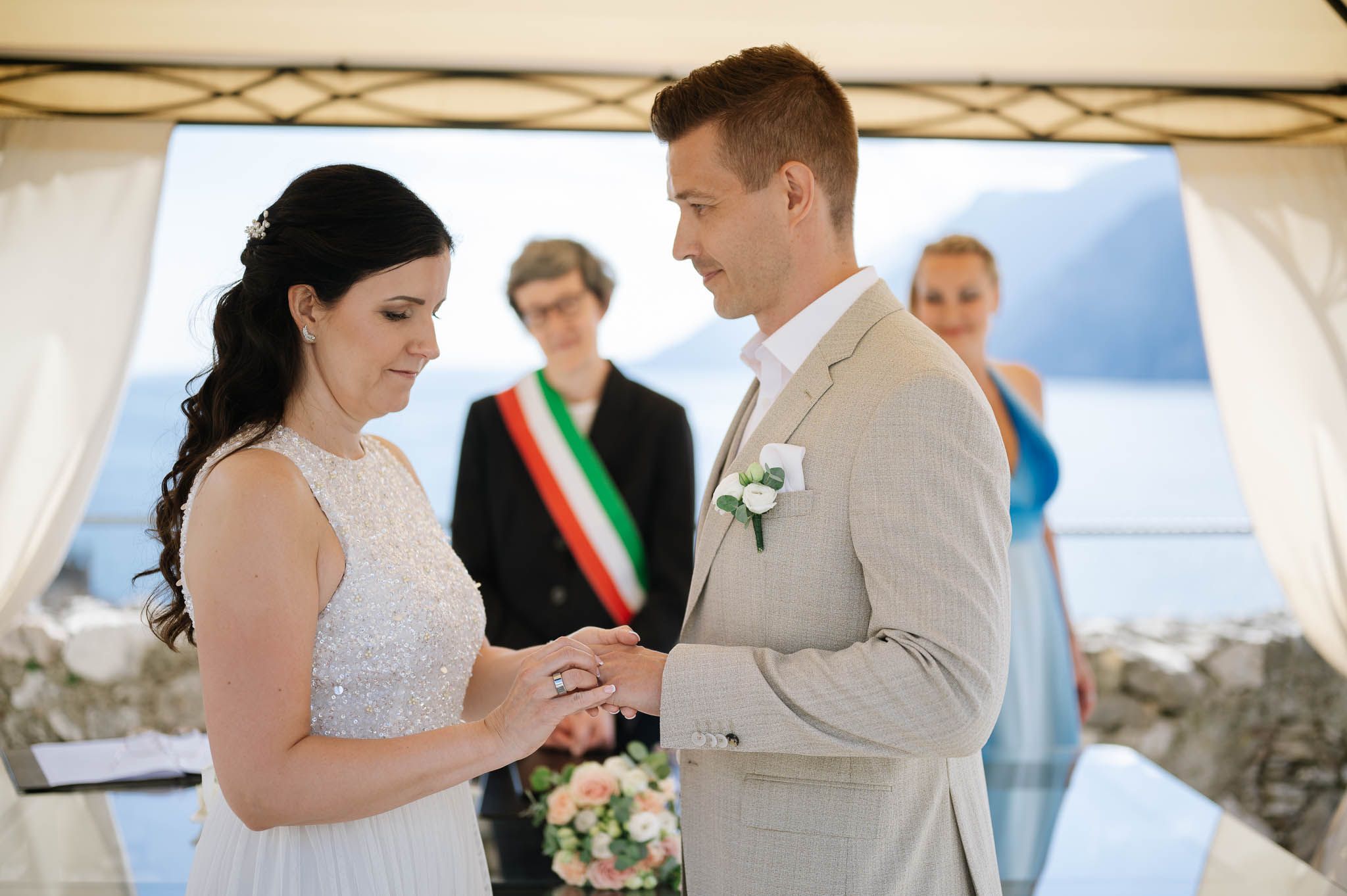 Bride and groom exchanging wedding rings during a Lake Garda destination wedding