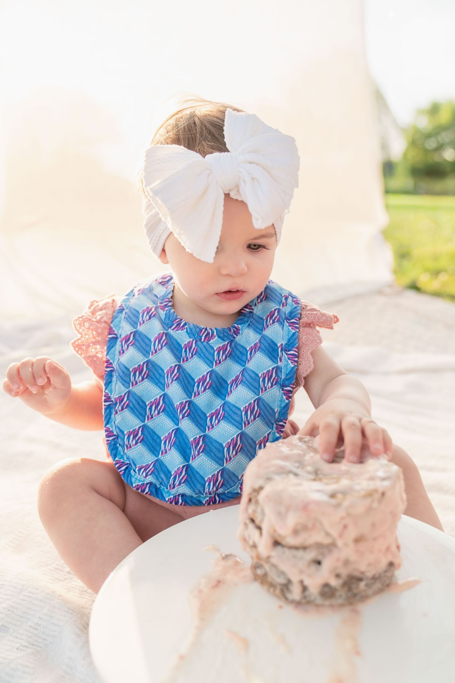 toddler girl cake smash one 1 year milestone outdoor photography, pink cake, conroe photographer