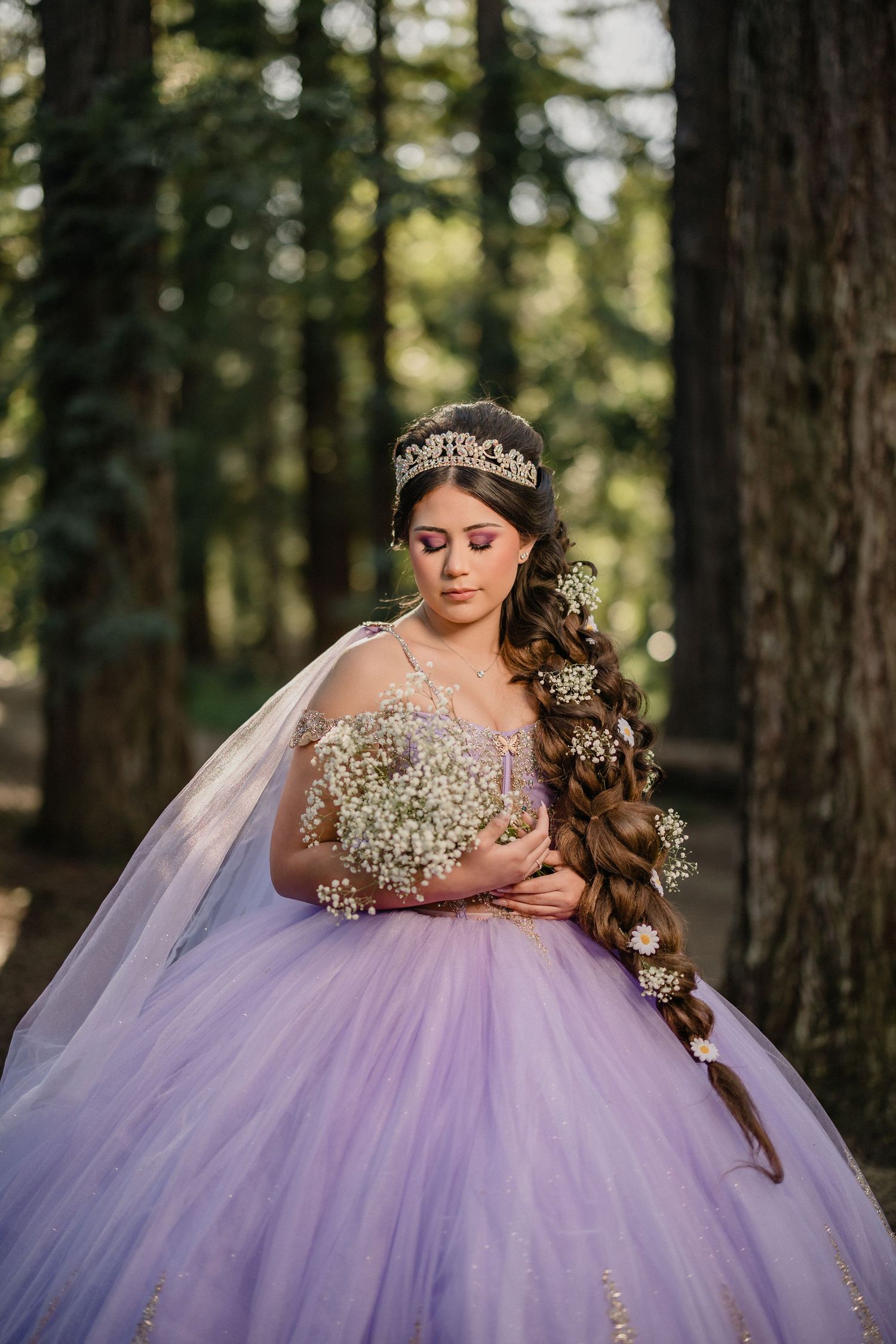 Woman in blue ballgown on ornate gold staircase in elegant mansion with arched windows and chandelier.