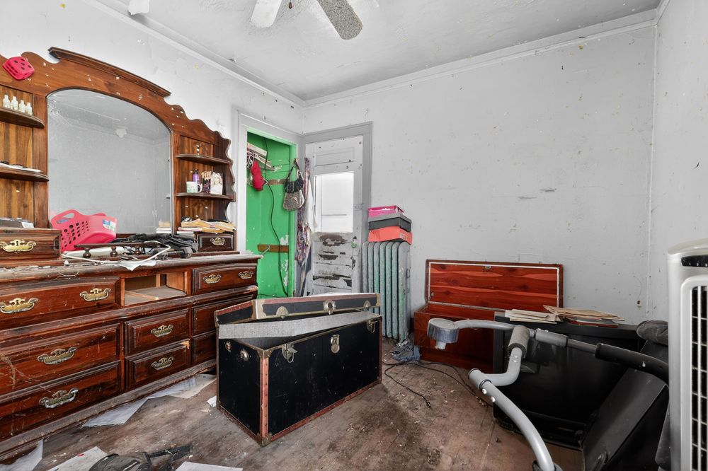 Water damage on ceiling and walls of living room in Detroit Michigan bank-owned property — condition documentation by RealtyPix