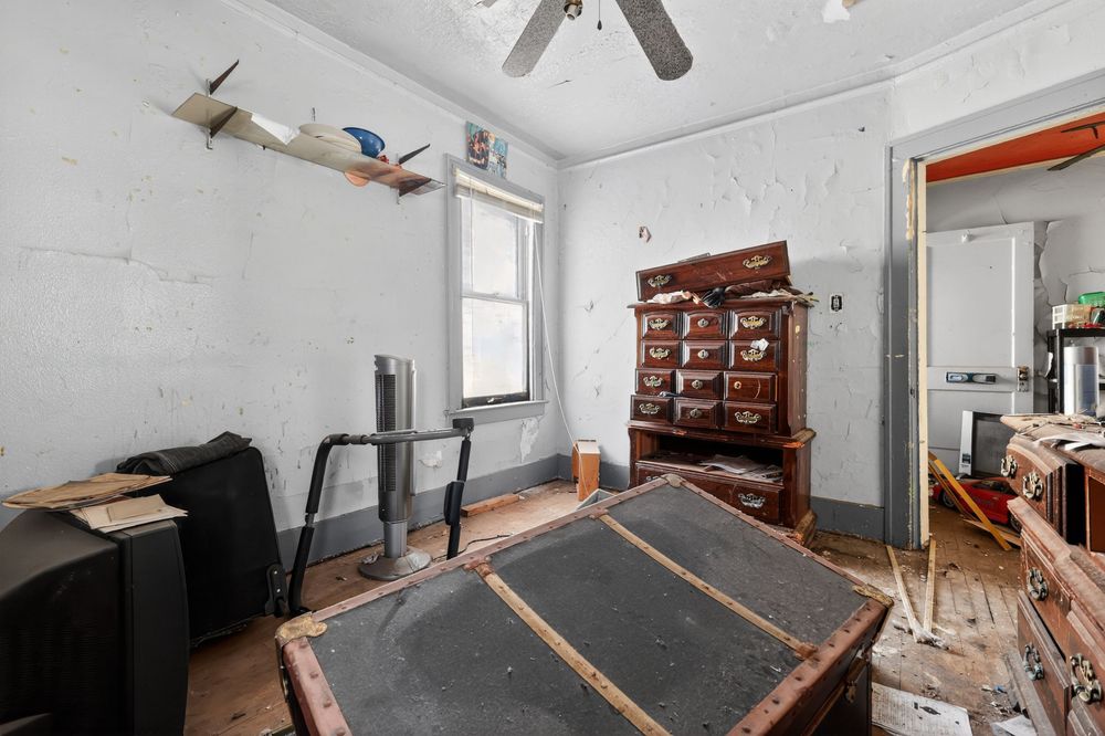Water damage on ceiling and walls of living room in Detroit Michigan bank-owned property — condition documentation by RealtyPix