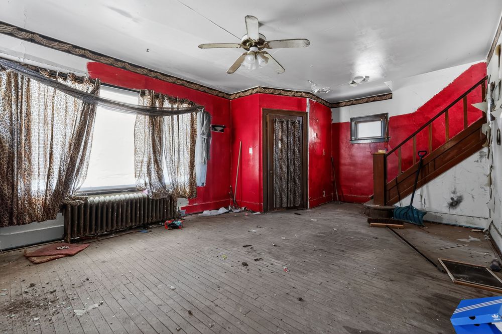Water damage on ceiling and walls of living room in Detroit Michigan bank-owned property — condition documentation by RealtyPix